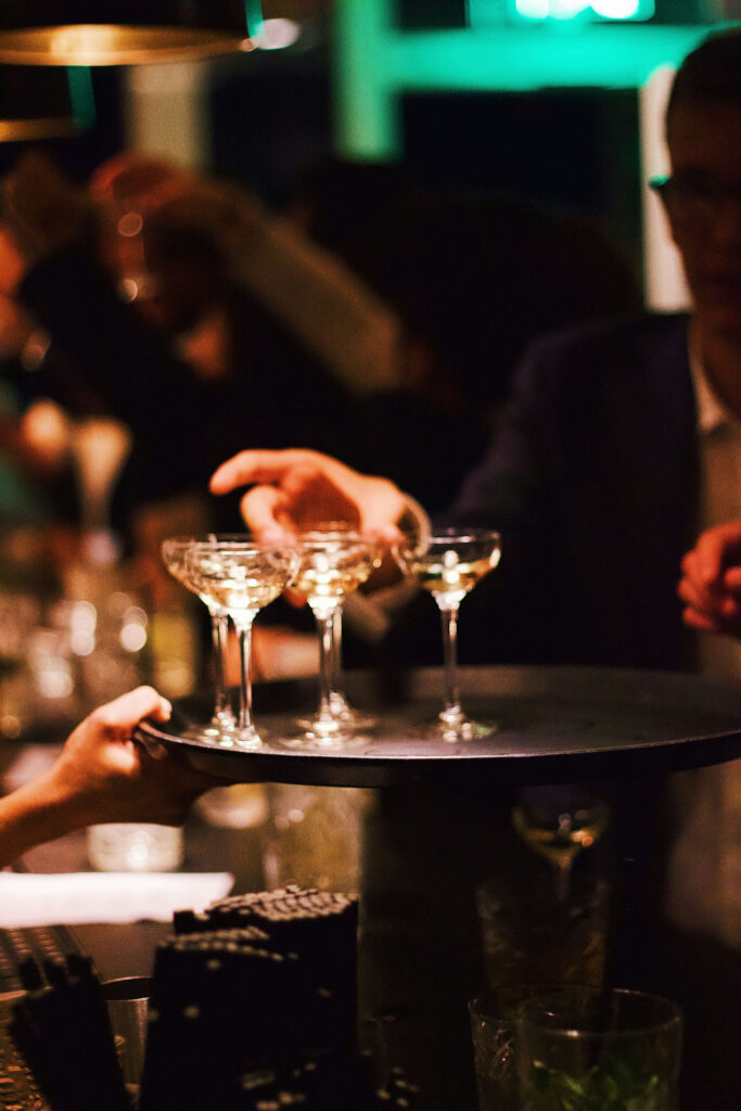 Server carrying a tray of champagne coupes